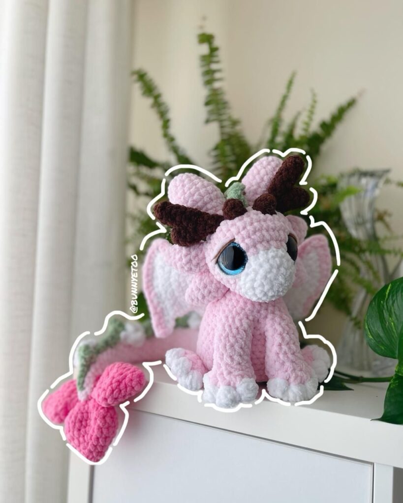 Ayanna, a pink crochet dragon with cherry blossom wings